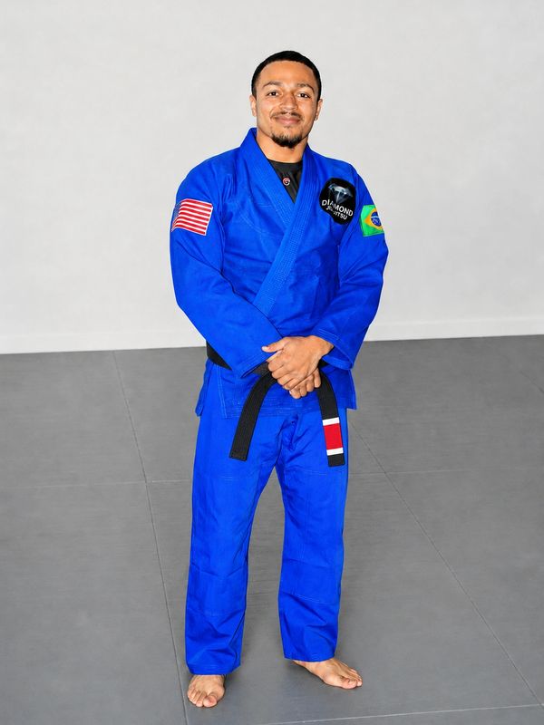 Professor Jacob Kassama, head instructor at Diamond Jiu-Jitsu, wearing his black belt